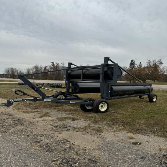 Alt text: Industrial black roller equipment on trailer with wheels, suitable for manufacturing projects.